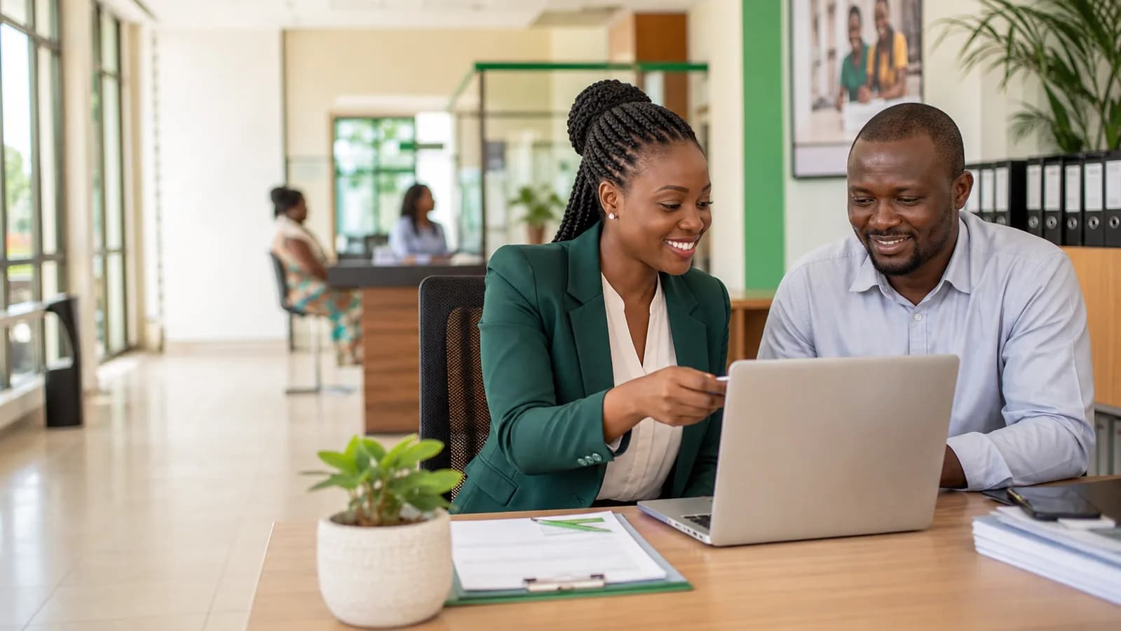 Loan officer helping a SACCO client with digital credit services
